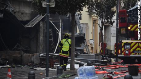 Un pompier se tient près des décombres et des maisons incendiées après l'explosion à Saint-Laurent-de-la-Salanque, le 14 février 2022. 